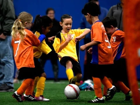 a group of kids playing football