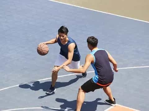 a couple of men playing basketball