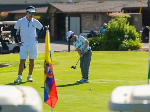 a couple of men playing golf