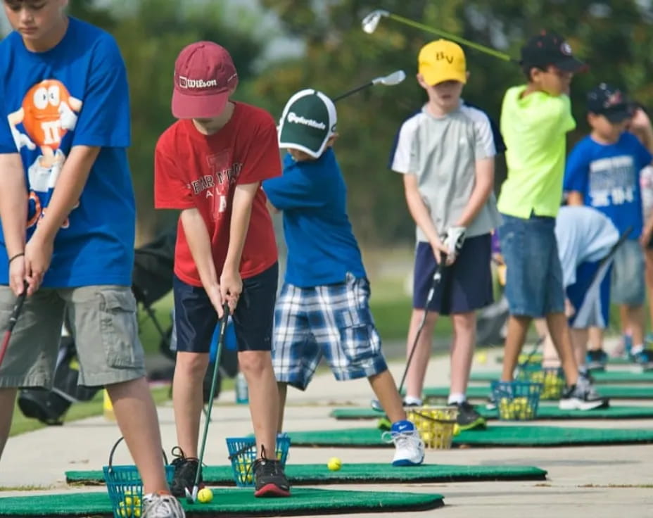 a group of kids playing golf