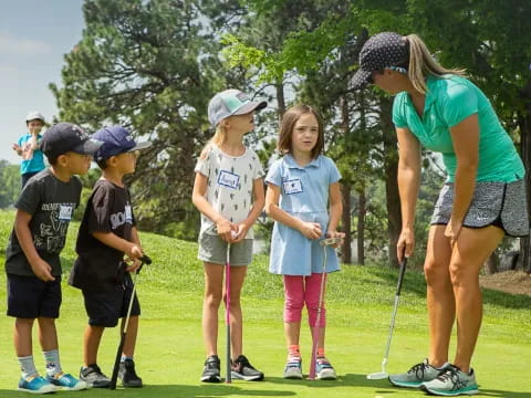 a group of kids playing golf