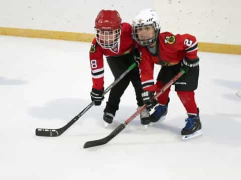 two people playing hockey