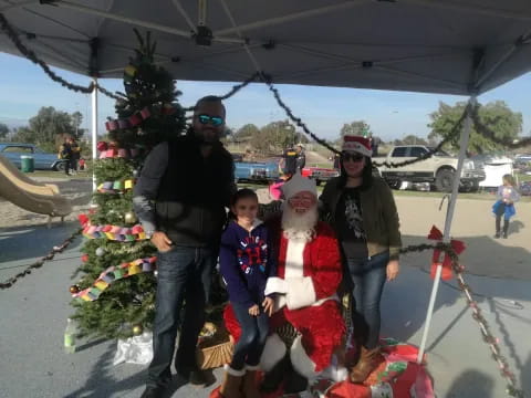 a group of people posing with a santa claus