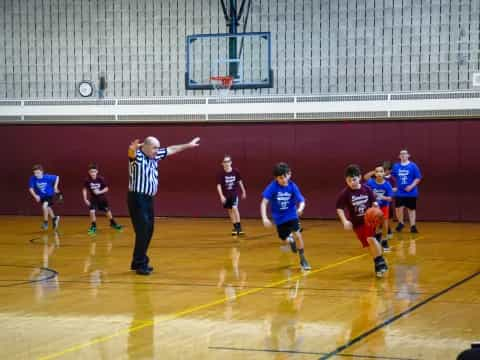 a group of people playing basketball