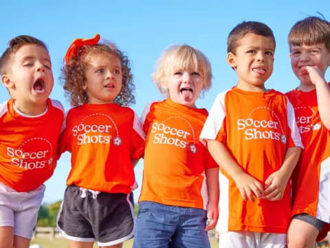 a group of children in red shirts