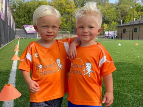 two boys in orange shirts