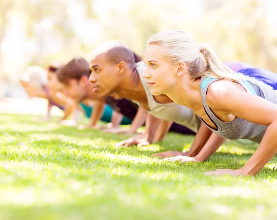 a group of people lying on the grass