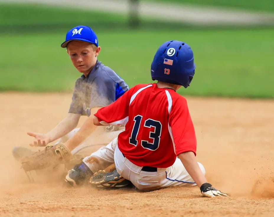 a couple of baseball players on the ground