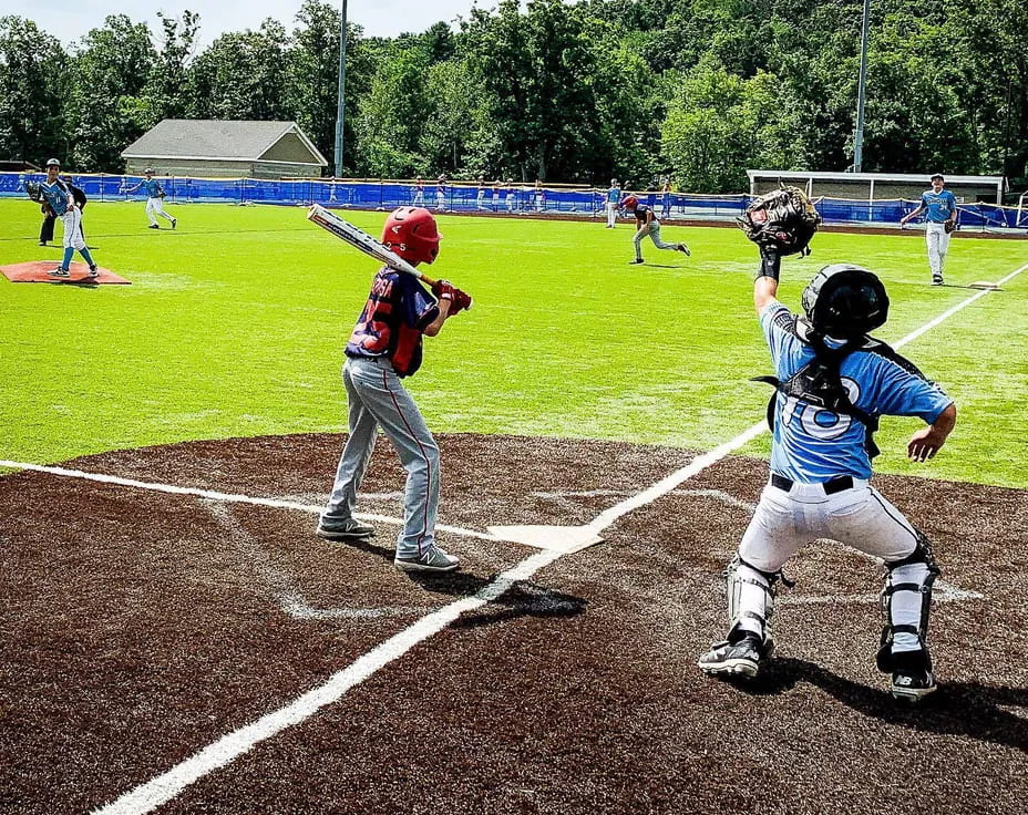 a baseball player prepares to swing a bat