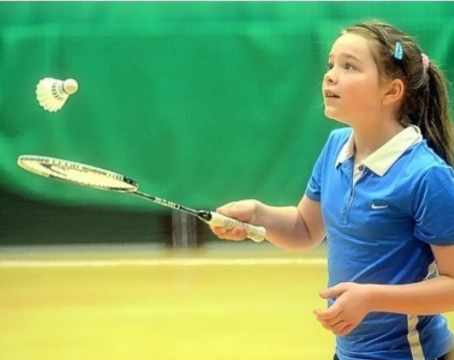 a girl swinging a tennis racket
