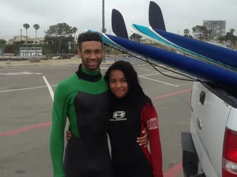 a man and woman posing for a picture with a shark fin on the back of a plane