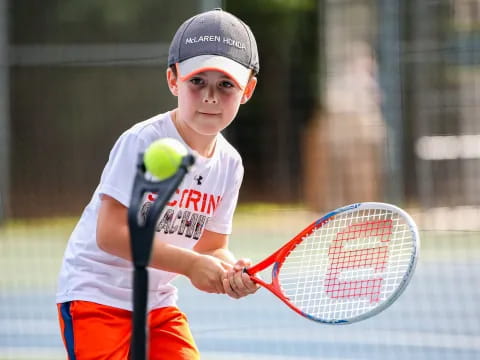 a person hitting a ball with a tennis racket