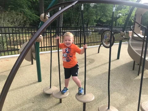 a boy on a playground swing