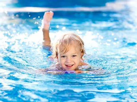 a child swimming in a pool