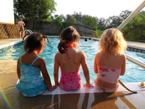 a group of children playing in a pool