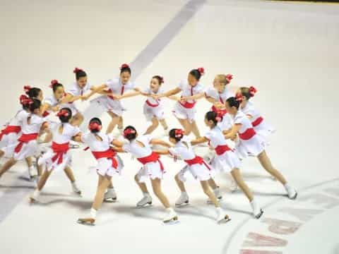 a group of people wearing white uniforms