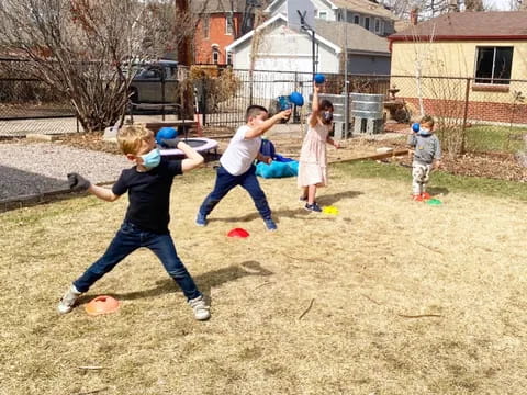 a group of kids playing baseball