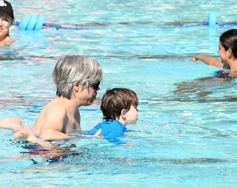 a man and a couple of children in a pool