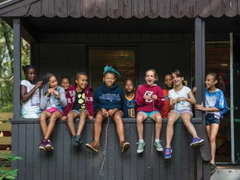 a group of people sitting on a porch