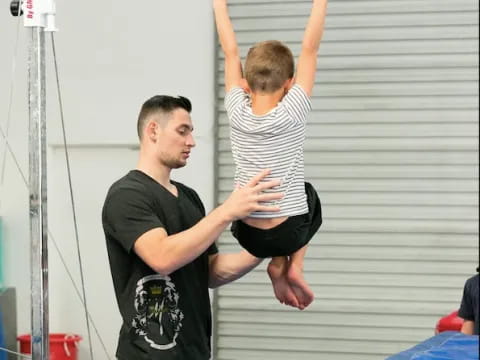 a person lifting a child up