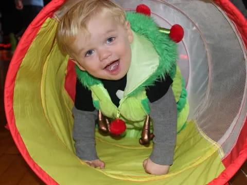 a baby in a green and yellow hammock