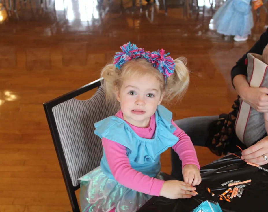 a little girl sitting in a chair