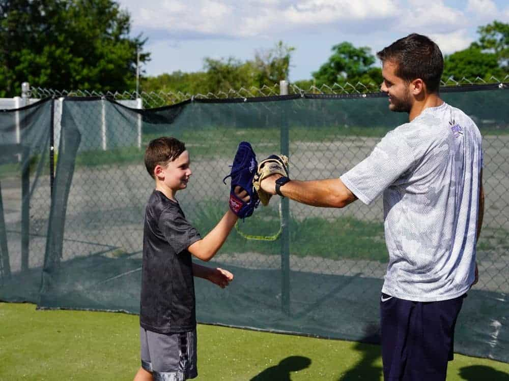 a man and a boy playing baseball