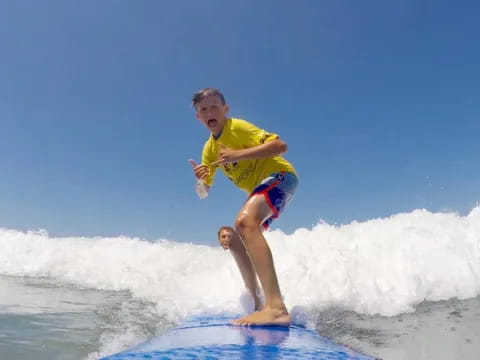 a boy riding a surfboard