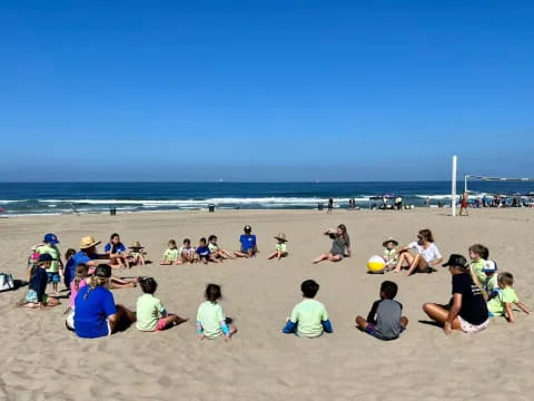a group of people sitting on a beach
