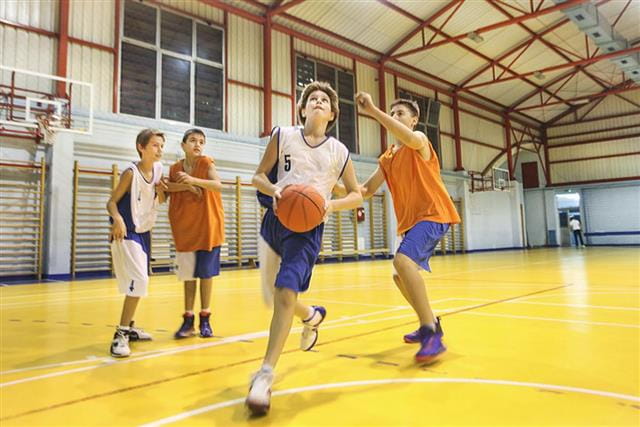 a group of people playing basketball