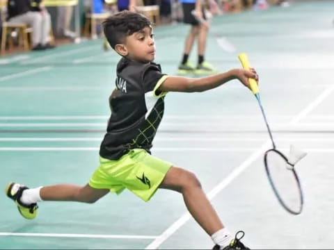 a boy playing tennis