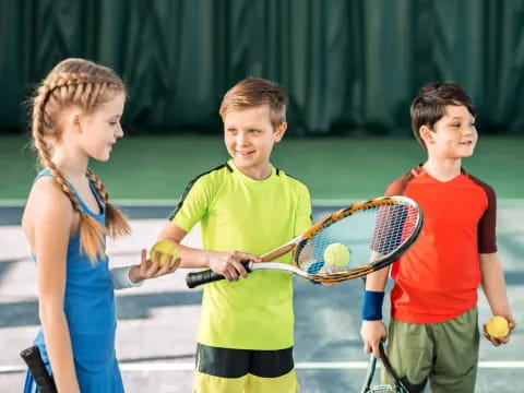 kids holding tennis rackets