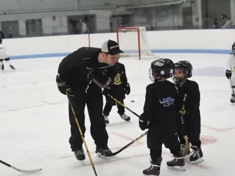 a person and kids playing hockey