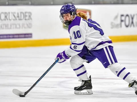 a man wearing a hockey uniform and helmet on ice