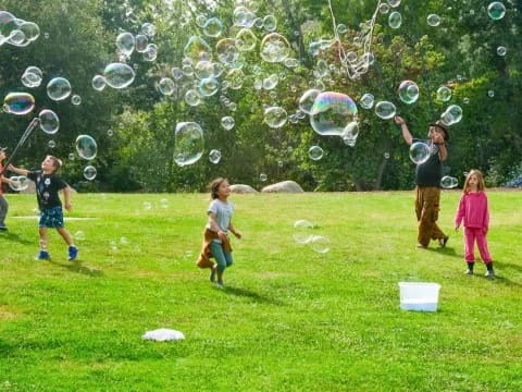 a group of people playing with bubbles