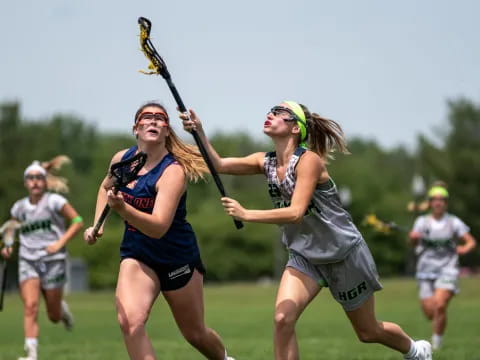 a group of women playing lacrosse