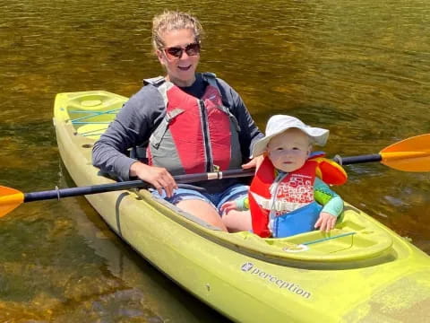 a person and a child in a canoe