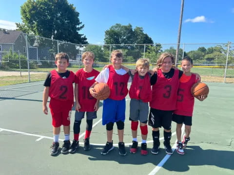 a group of kids holding basketballs