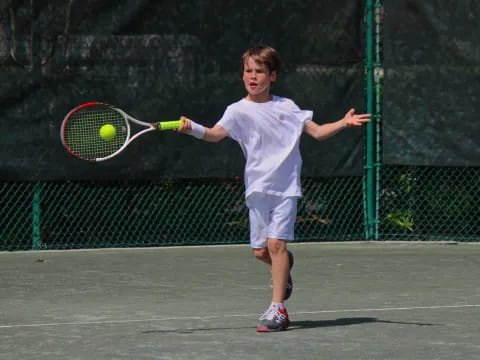 a boy playing tennis