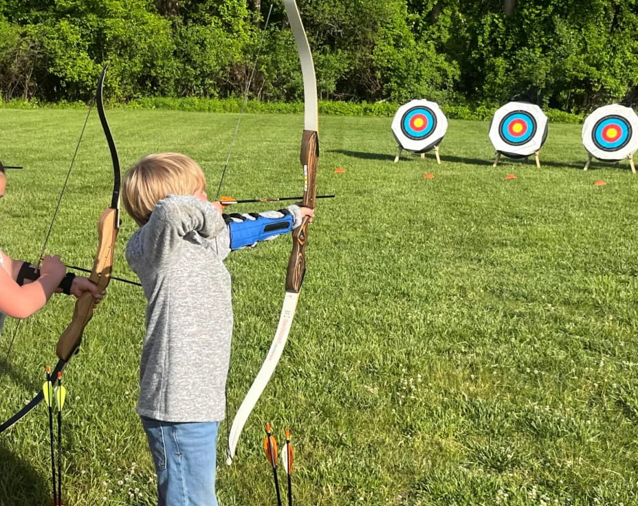 a couple of kids shooting bows