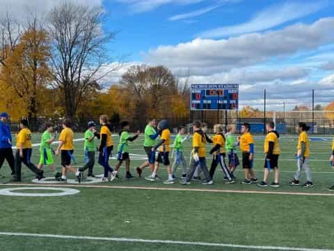 a group of people on a football field