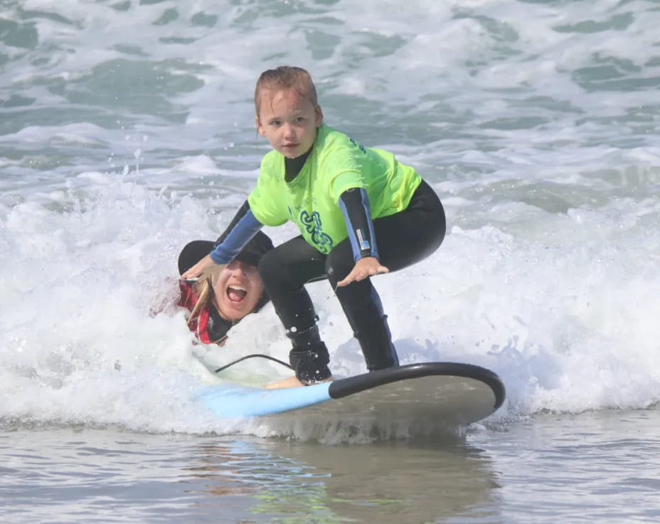 a couple of people surfing in the sea