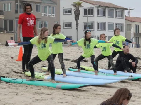 a group of people stand on surfboards