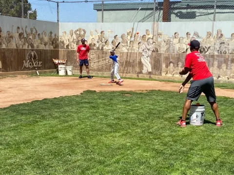 a group of people playing baseball