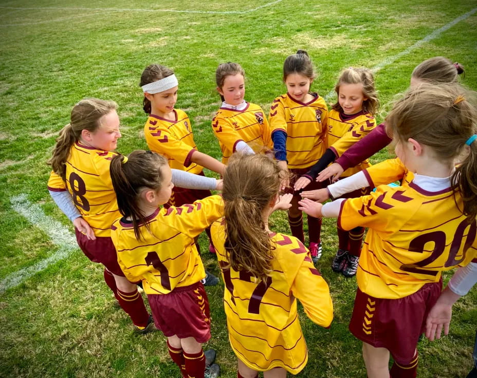 a group of children in yellow uniforms