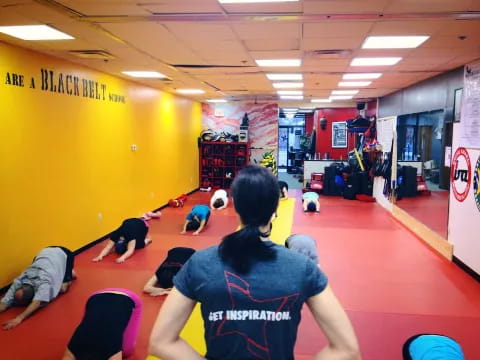 a group of people exercising in a gym