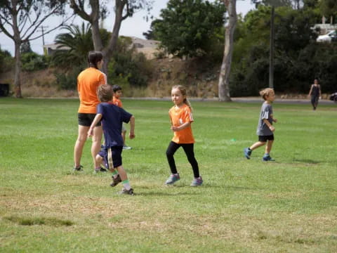 a group of kids playing football