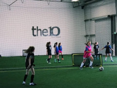 girls playing football on a field