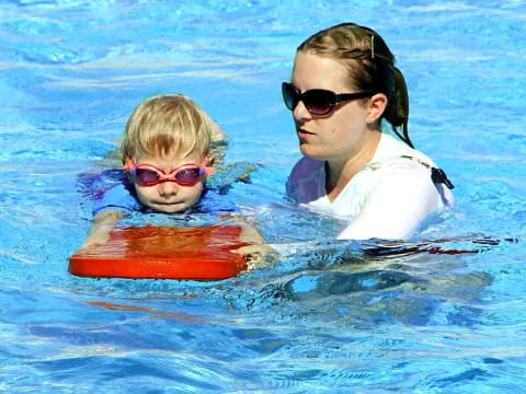 a person and a boy in a pool