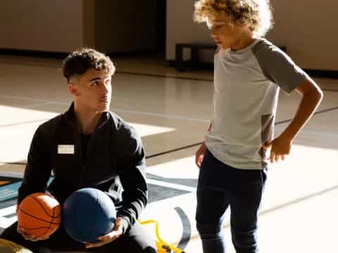 a boy and a girl playing basketball